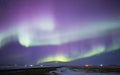 Aurora borealis over rural landscape