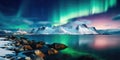 Aurora borealis over the sea, snowy mountains and city lights at night. Northern lights in Lofoten islands, Norway. Starry sky