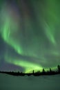 Aurora borealis over snowy winter landscape, Finnish Lapland Royalty Free Stock Photo