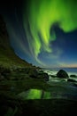 Aurora Borealis reflected in a rock pool, Utakleiv beach Royalty Free Stock Photo