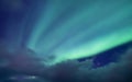 Aurora Borealis, Senja Islands, Norway. Stars, moving clouds and northern light. Night landscape. Natural background. Royalty Free Stock Photo