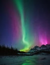 Aurora borealis shining over mountain range, night sky mesmerizing dance Northern Lights Royalty Free Stock Photo