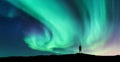 Aurora borealis and silhouette of standing man