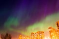 Aurora borealis starry night over the city and houses Royalty Free Stock Photo