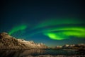 Aurora Borealis in Tromso, Norway in front of the Norwegian fjord, winter season, long shutter speed Royalty Free Stock Photo