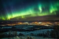 aurora dancing across starry night sky, with view of distant town visible in the foreground