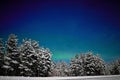 Aurora on night winter sky. Winter road night background. Royalty Free Stock Photo