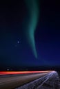 Northern lights on night road on the Yamal Peninsula in Russia