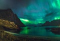 Aurora over sandy beach haukland, Kvalvika and Skagsanden with stones in Norway, Lofoten islands. Northern lights in Royalty Free Stock Photo