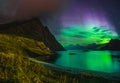 Aurora over sandy beach haukland, Kvalvika and Skagsanden with stones in Norway, Lofoten islands. Northern lights in Royalty Free Stock Photo