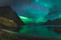 Aurora over sandy beach haukland, Kvalvika and Skagsanden with stones in Norway, Lofoten islands. Northern lights in Royalty Free Stock Photo