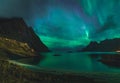 Aurora over sandy beach haukland, Kvalvika and Skagsanden with stones in Norway, Lofoten islands. Northern lights in Royalty Free Stock Photo