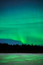 Aurora reflecting in a frozen lake