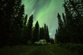 Aurora shining over Camping Caravan in Swedish forest Tannforsen Waterfall Northern Lights color sky Sweden, Scandinavia