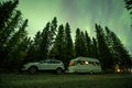 Aurora shining over Camping Caravan in Swedish forest Tannforsen Waterfall Northern Lights color sky Sweden, Scandinavia