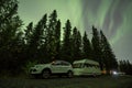 Aurora shining over Camping Caravan in Swedish forest Tannforsen Waterfall Northern Lights color sky Sweden, Scandinavia