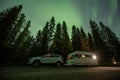 Aurora shining over Camping Caravan in Swedish forest Tannforsen Waterfall Northern Lights color sky Sweden, Scandinavia