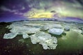 Auroral over the glacier lagoon Jokulsarlon in Iceland.