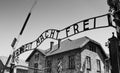 Auschwitz Concentration Gate, ARBEIT MACHT FREI sign. Sunny day on the July 7th, 2015. Black and white. Krakow, Poland Royalty Free Stock Photo