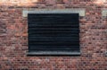 Auschwitz, Poland - Brick stone wall with closed wooden shutters at the concentration camp Royalty Free Stock Photo