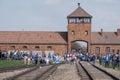 The security tower at the entrance to Auschwitz Birkenau concentration camp with group of kids on March of the Living. Royalty Free Stock Photo