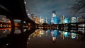 Austin skyline at night and Lamar pedestrial Bridge with bright illuminated buildings reflecting in Lady Bird Lake