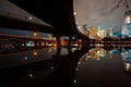 Austin skyline at night and Lamar pedestrial Bridge with bright illuminated buildings reflecting in Lady Bird Lake