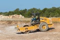 An experienced opearor controlling a Caterpillar C556B compactor