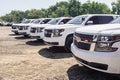 A fleet of White Chevy Tahoe equipped with Feniex Emergency Products