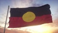 Australia Aboriginal flag waving in the wind, sky and sun background. 3d rendering Royalty Free Stock Photo