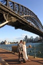 Australia bride and groom walks under Sydney Harbour Bridge Sydney New South Wales Australia Royalty Free Stock Photo
