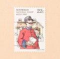 A stamp printed in Australia shows a mail man, circa 1980 Royalty Free Stock Photo