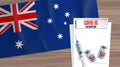 Australia covid 19 vaccination sheet blank document vaccine vials syringe and Australian flag on wooden table Royalty Free Stock Photo