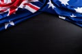 Australia day concept. Australian flag with the text Happy Australia day against a blackboard background. 26 January