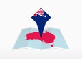 Australia is depicted on a folded paper map and pinned location marker with flag of Australia Royalty Free Stock Photo