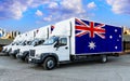 Australia flag on the back of Five new white trucks against the backdrop of the river and the city. Truck, transport, freight Royalty Free Stock Photo