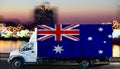 Australia flag on the side of a white van against the backdrop of a blurred city and river. Logistics concept