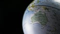 Australia map on a globe with black background. Royalty Free Stock Photo