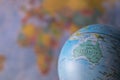 Australiamap on a globe with earth map in the background. Royalty Free Stock Photo