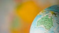 Australia map on a globe with earth map in the background. Royalty Free Stock Photo