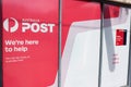 Australia Post post office boxes and shop advertisement sign Royalty Free Stock Photo