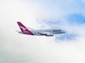 QANTAS A380 flying through a cloudy sky.