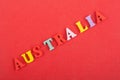 AUSTRALIA word on red background composed from colorful abc alphabet block wooden letters, copy space for ad text Royalty Free Stock Photo