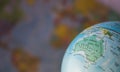 Australiamap on a globe with earth map in the background. Royalty Free Stock Photo