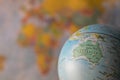Australiamap on a globe with earth map in the background. Royalty Free Stock Photo