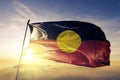 Australian Aboriginal flag textile cloth fabric waving on the top sunrise mist fog Royalty Free Stock Photo