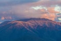 Australian Alps in orange sunset light and low clouds. Royalty Free Stock Photo