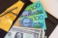 Australian and American dollars with spectacles and a black leather wallet. Royalty Free Stock Photo