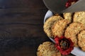 Australian army slouch hat and traditional Anzac biscuits on dark recycled wood with copy space