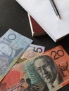 Australian banknotes, black pen and books Royalty Free Stock Photo